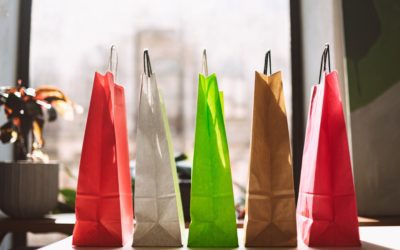 Close up colorful shopping bags on table with big window on back