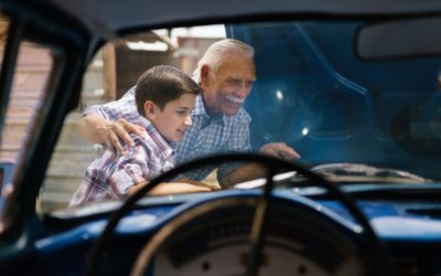 Boy With Grandpa Looking Car Engine Of Senior Man