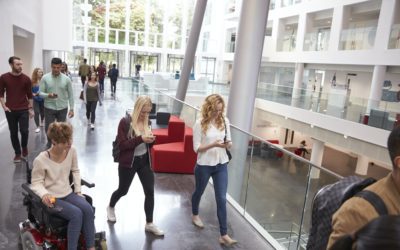 Students walk and talk using mobile devices in university