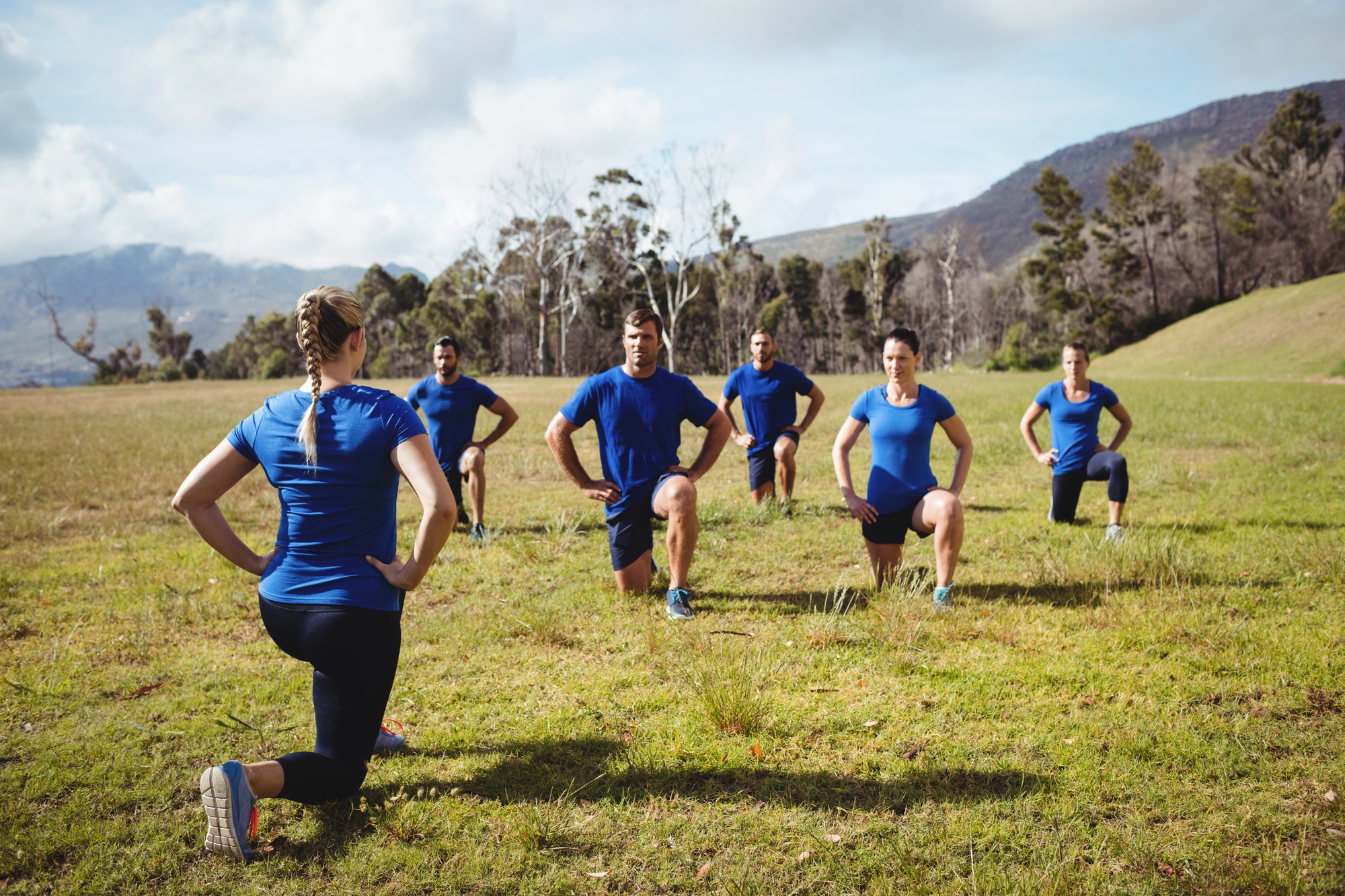 Female trainer giving training to fit people