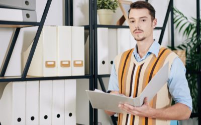 Businessman searching for document in archive