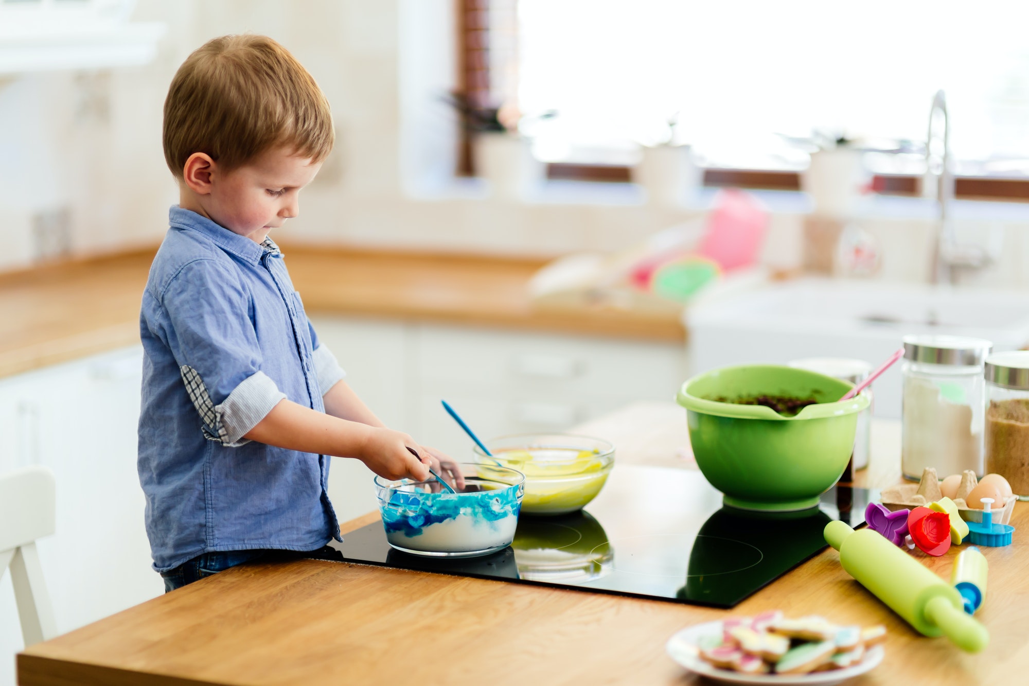 Cute child learning to become a chef since the age of 2