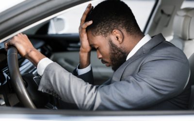 Stressed businessman feeling headache in car, stop the car