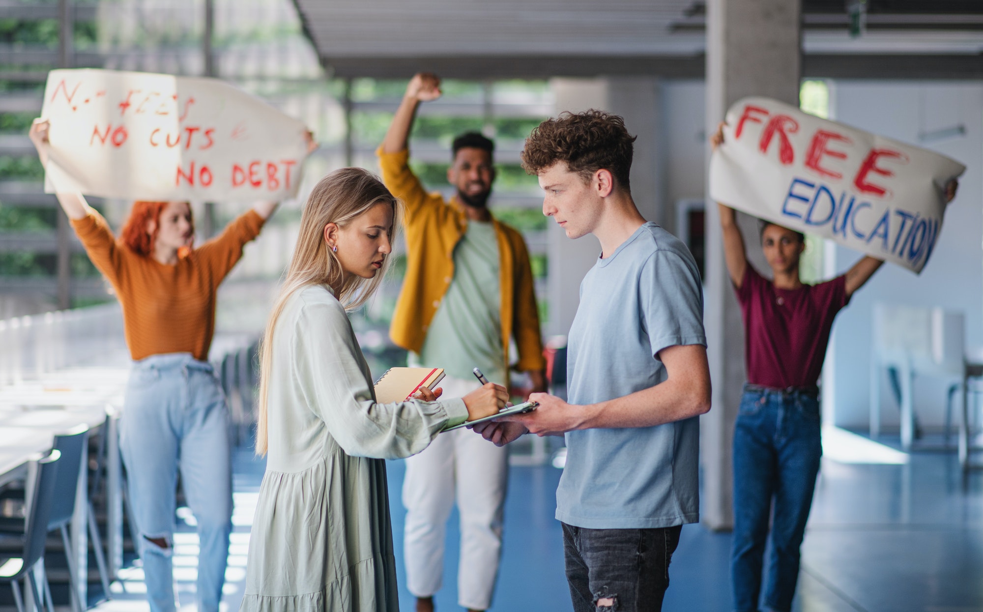University students activists protesting indoors, fighting for free education concept