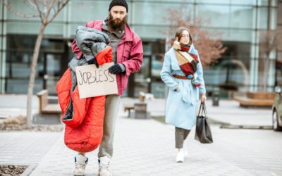 Homeless beggar with passing by business woman