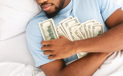 Man sleeping with lots of currency notes