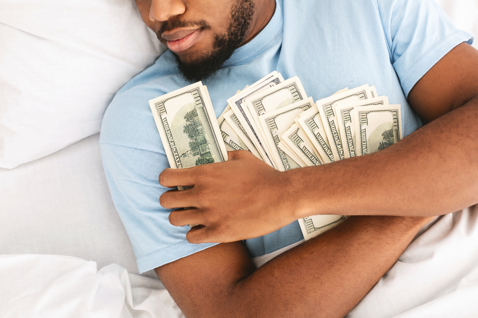 Man sleeping with lots of currency notes