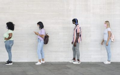 Young people from different cultures and race waiting in queue outside shop market