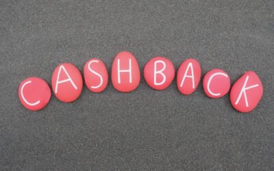 Cashback, reward program word composed with red colored stone letters over black sand