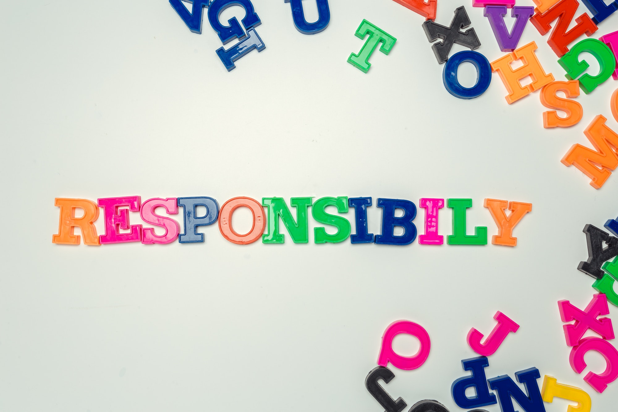 Responsibility word made from colorful plastic letters on white background