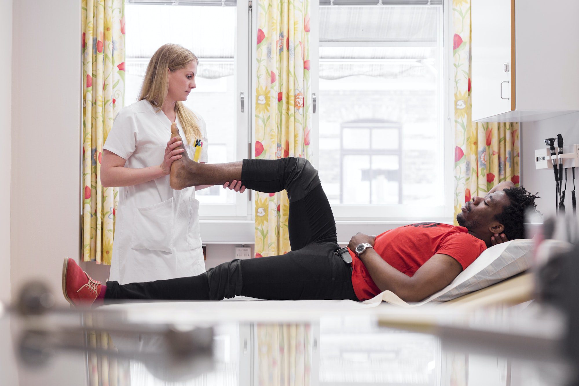 Young man with doctor during medical procedure