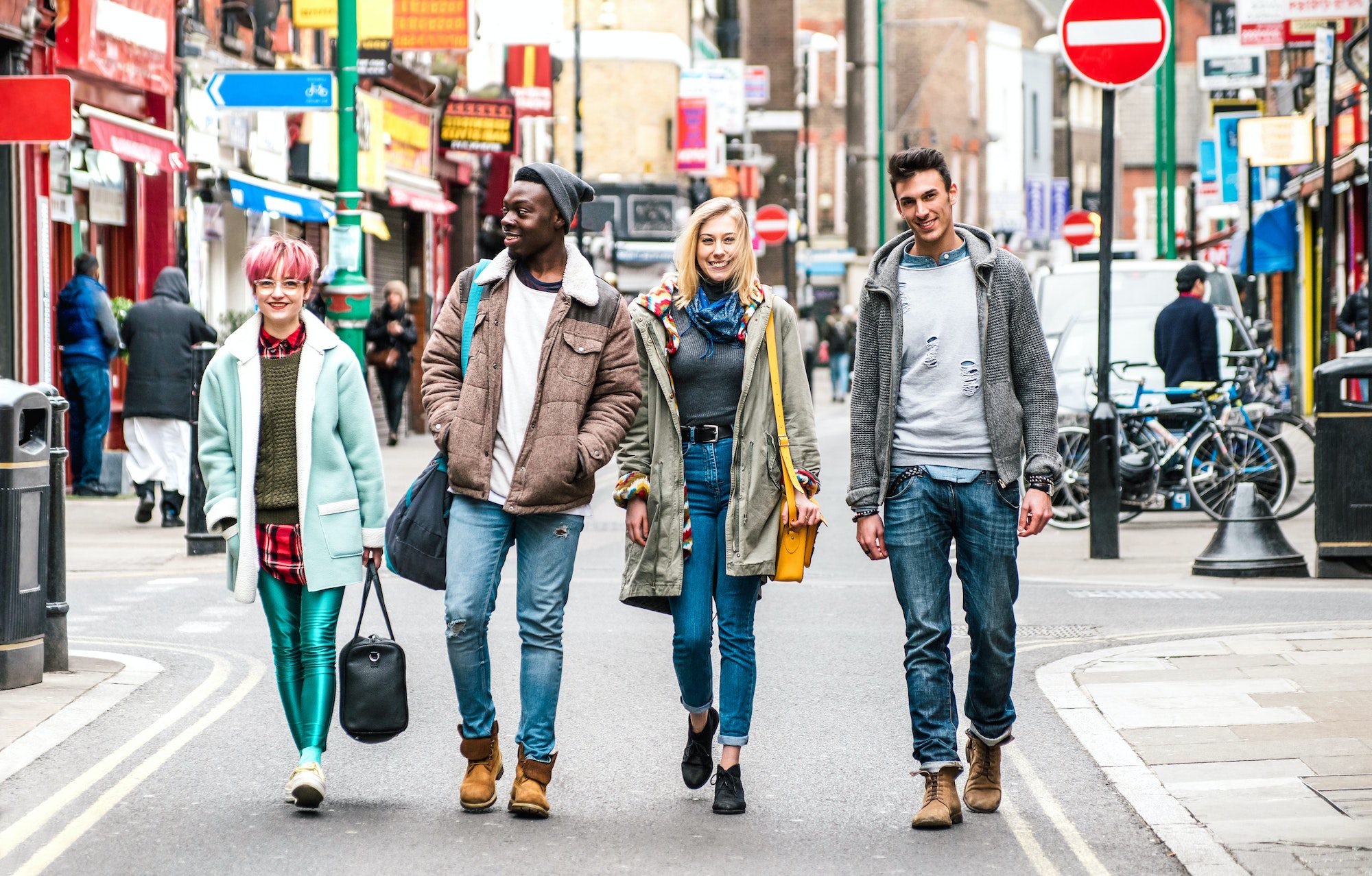 Multicultural students walking on Brick Lane center at Shoreditch London