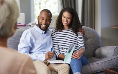 Happy young couple taking financial advice at home