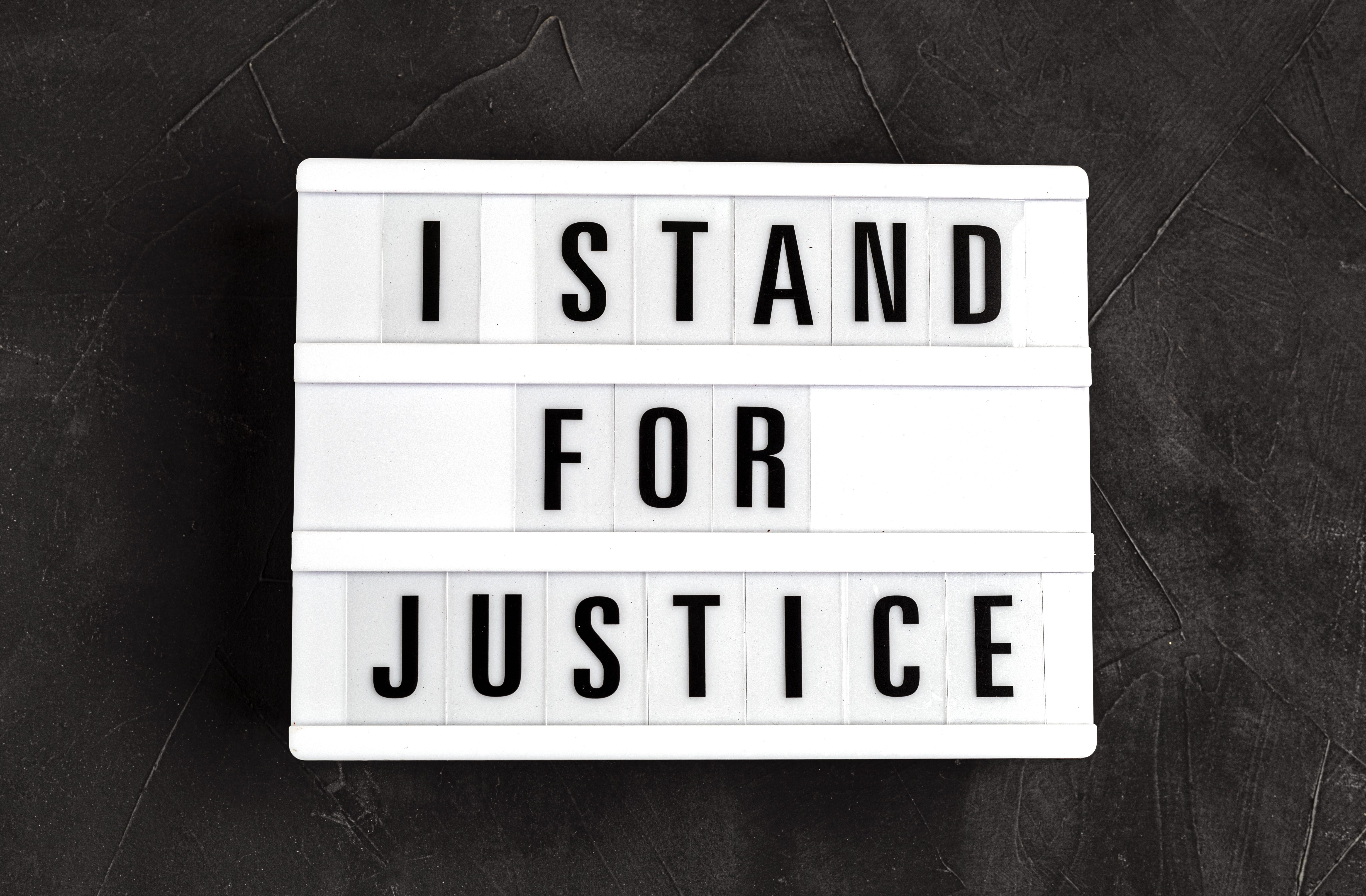 I stand for justice text on light box on dark background