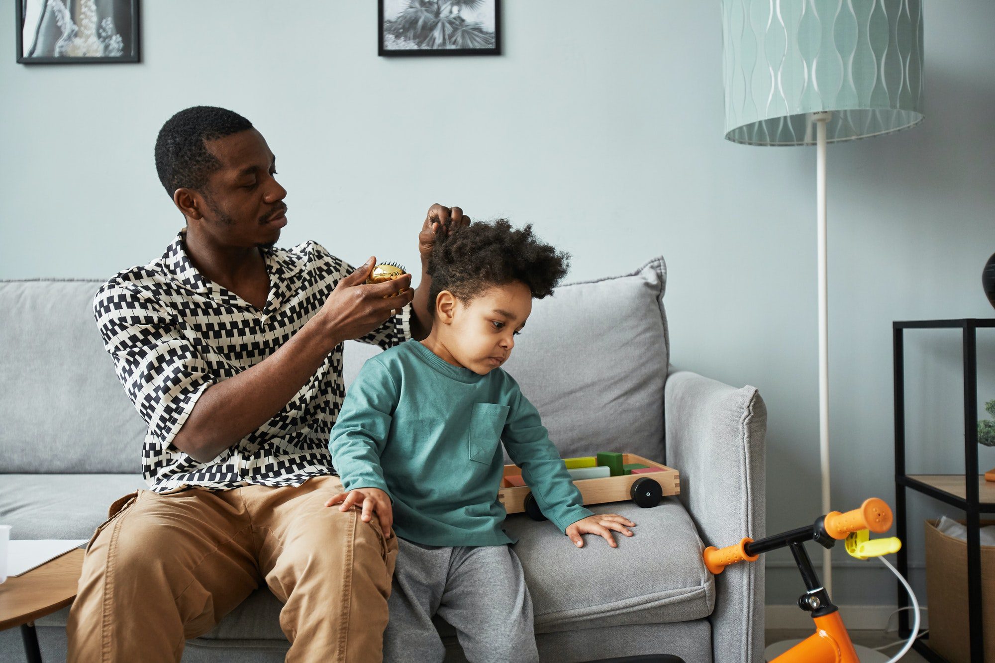 Father Taking Care of Curly Black Hair