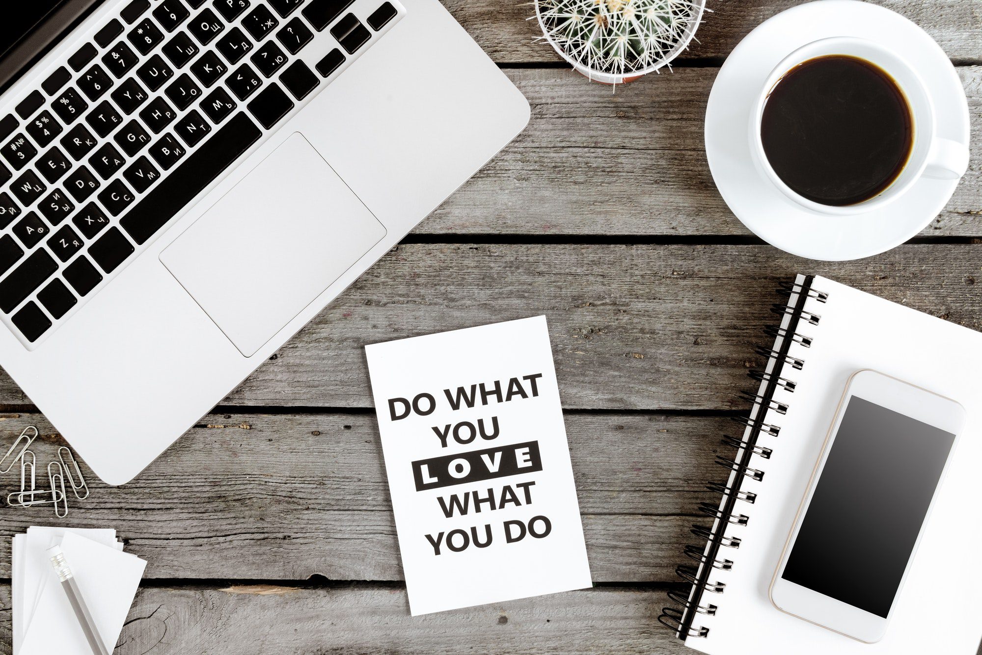 top view of Do what you love and love what you do motivational quote on modern workplace with