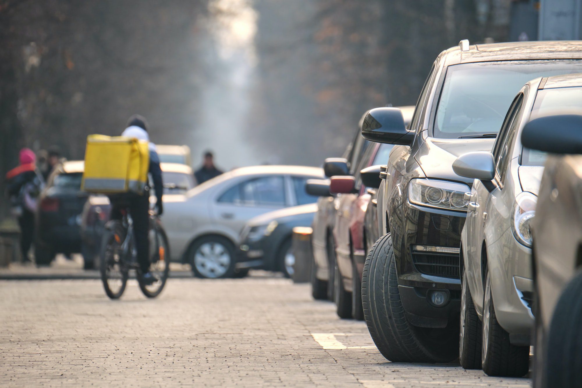 City traffic with cars parked in line on street side