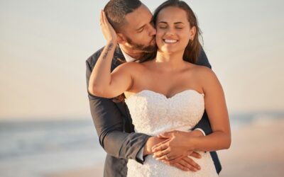 Wedding kiss, beach reception and couple in celebration of marriage at the ocean and bride and groo