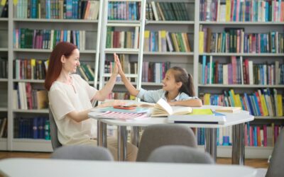Woman and girl touching raised hand as sign of understanding