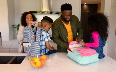 Happy african american parents and children preparing backpacks for school