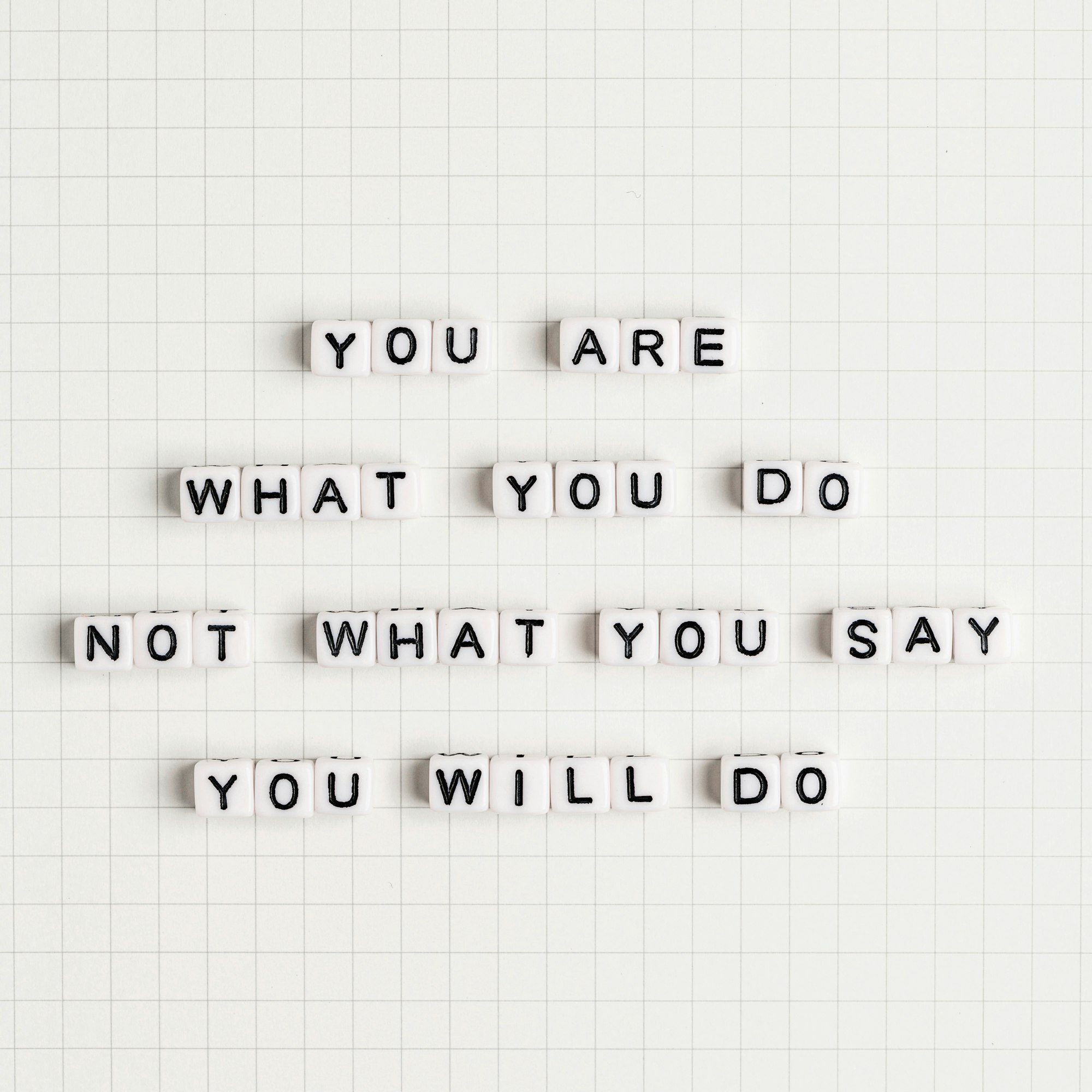 YOU ARE WHAT YOU DO NOT WHAT YOU SAY YOU WILL DO beads message typography