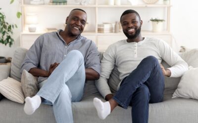 Like Father Like Son. Happy Man Sitting In Similar Pose With Dad