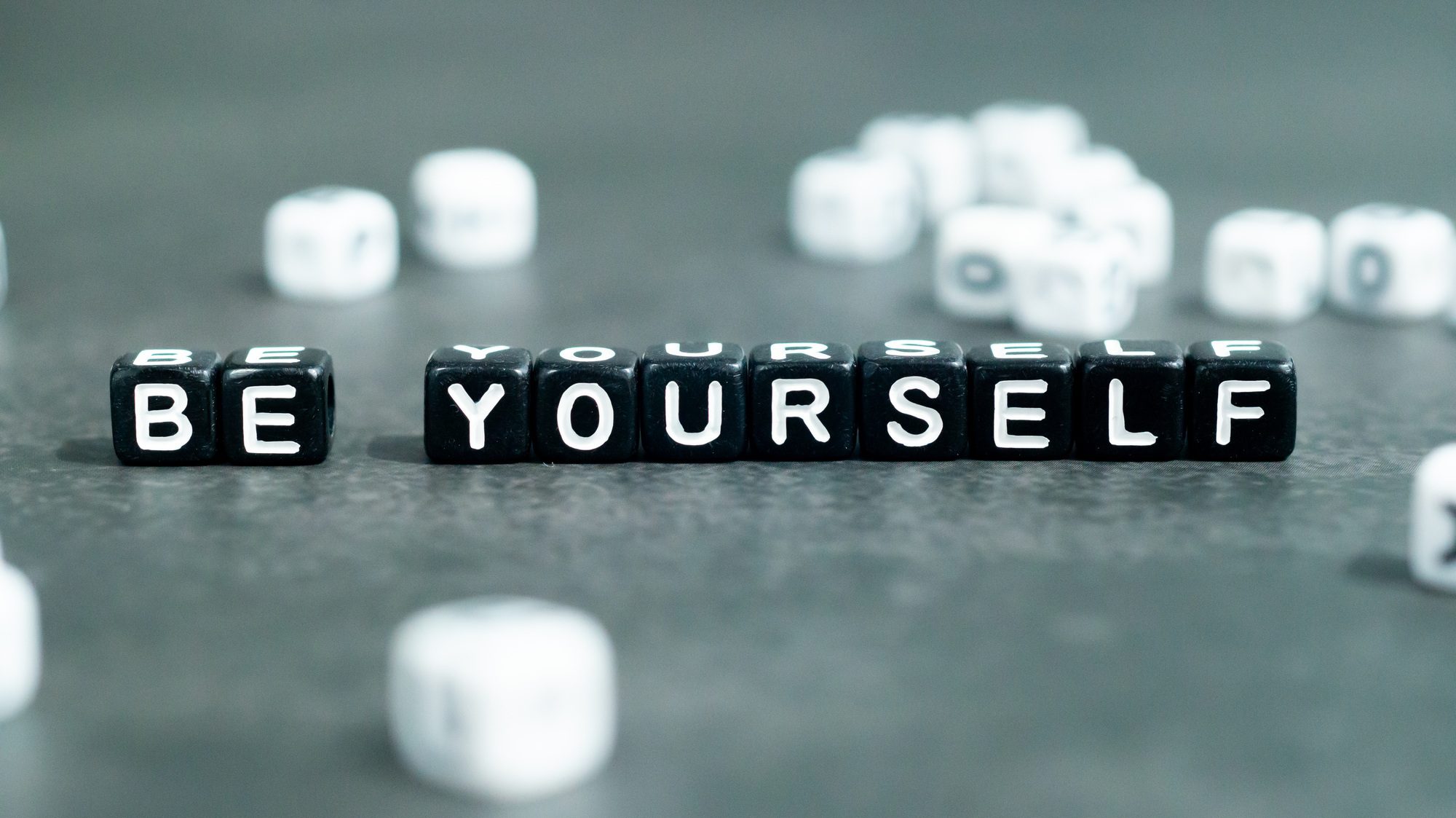 Be yourself slogan in black bead letters. Motivation inspiration self confidence uniqueness concept
