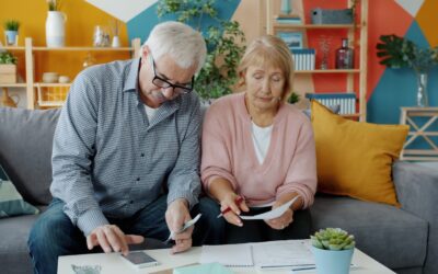Elderly couple reviewing documents at home