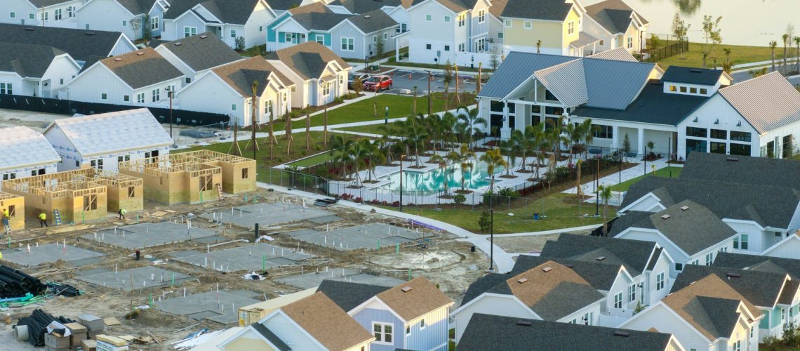 Aerial view of unfinished wooden frames of affordable houses under construction