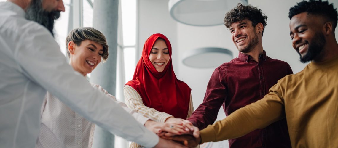 Business people joining hands, stacking hands, teamwork concept
