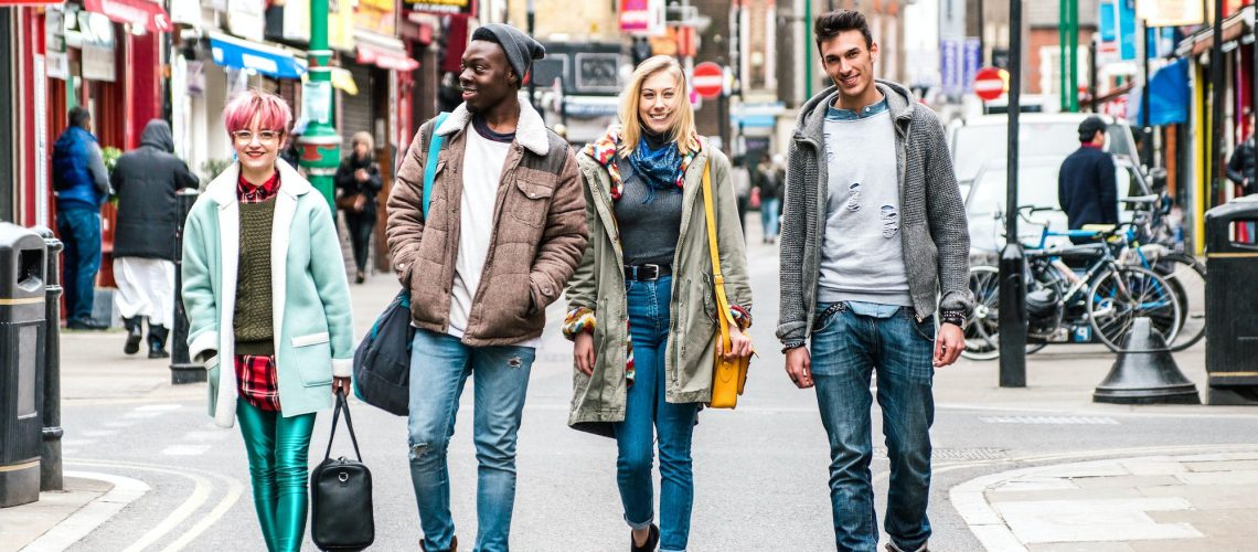 Multicultural students walking on Brick Lane center at Shoreditch London