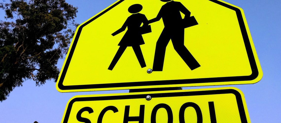 School zone crossing sign with people