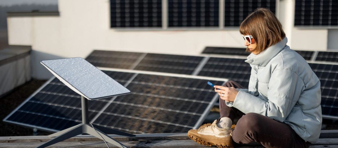 Woman uses Starlink Internet on roof with solar panels
